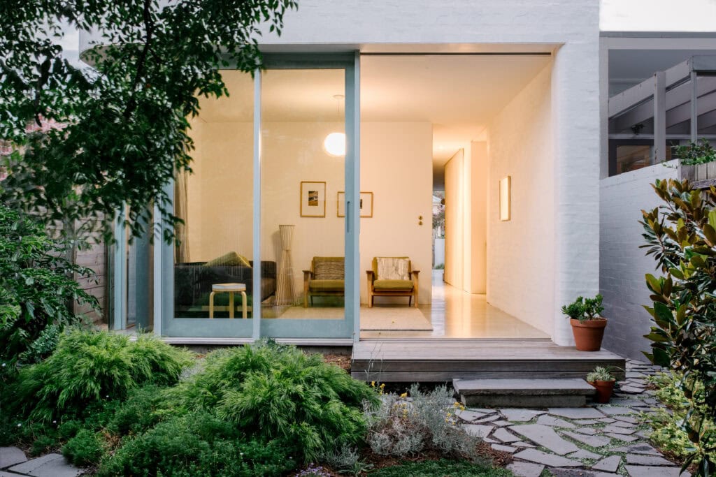 Contemporary beach house with large glass doors and lush garden in South Melbourne.