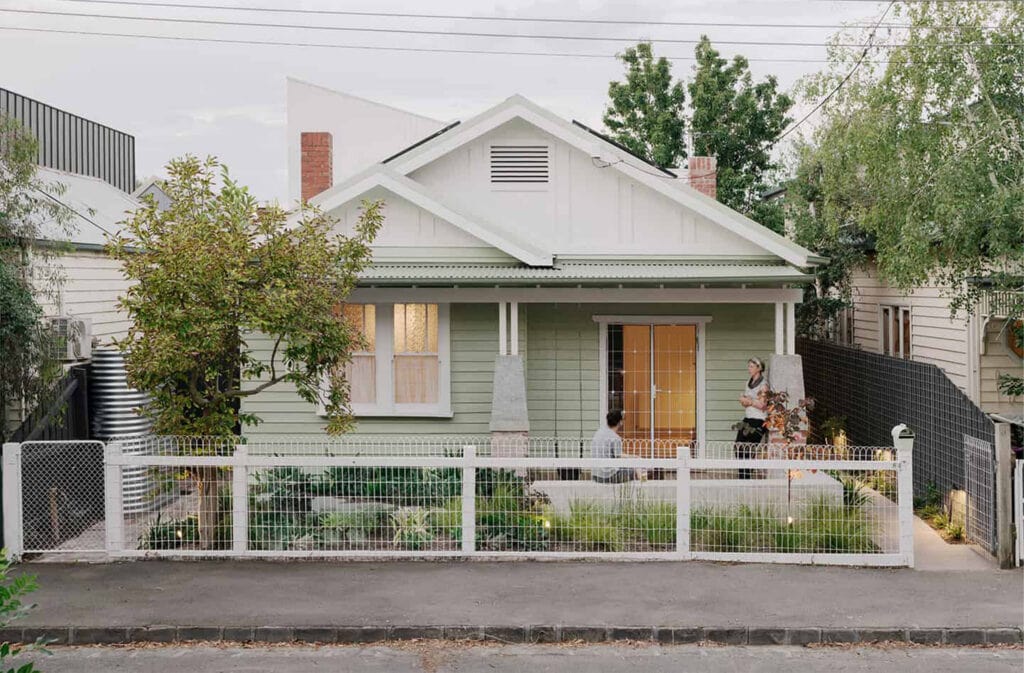 Australian home with garden, front fence, and outdoor seating area.