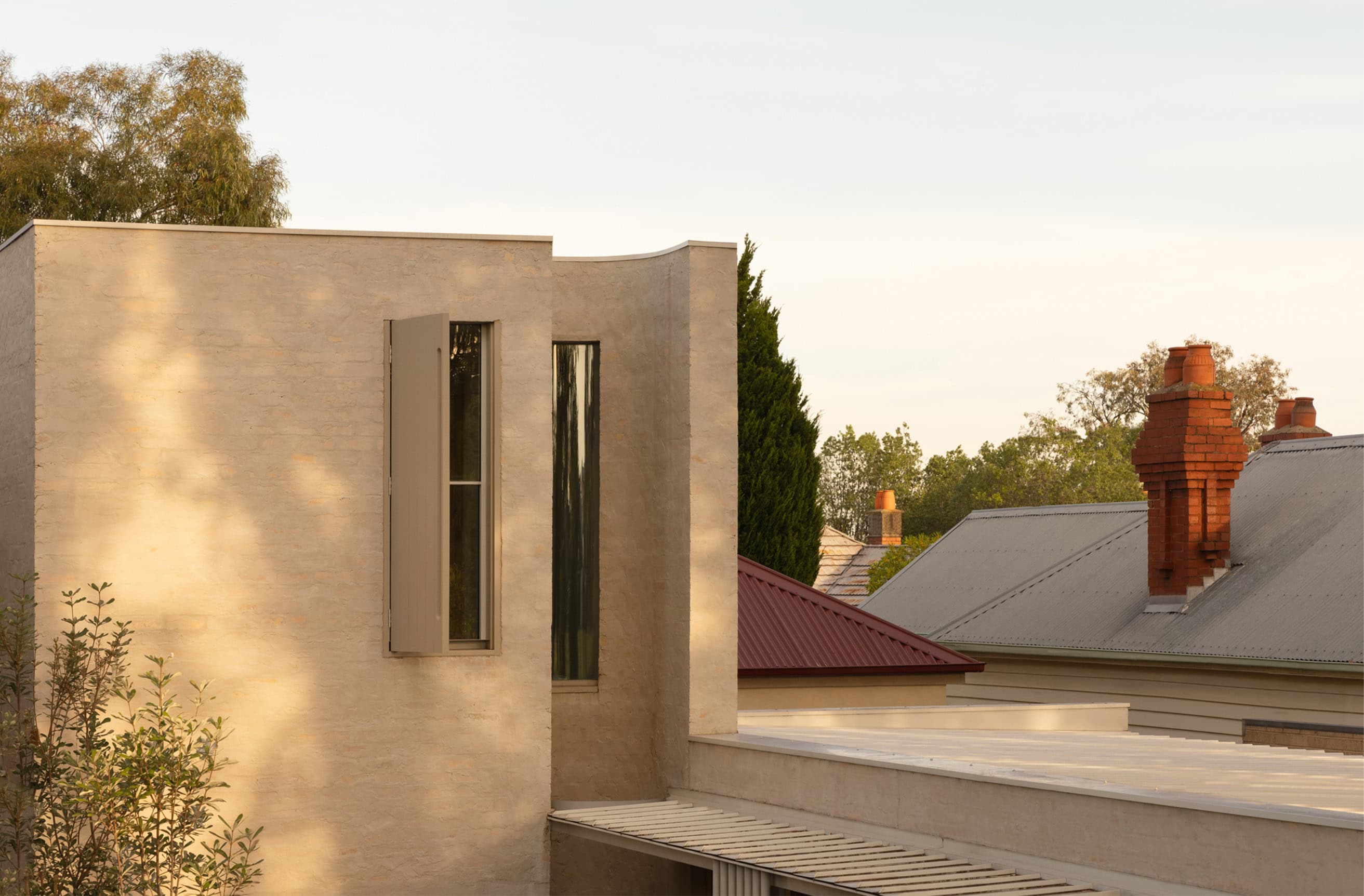 Contemporary architecture featuring sleek concrete walls and tall narrow windows.